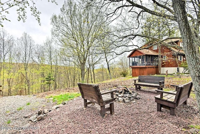 view of property's community featuring an outdoor fire pit