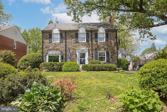 104 Lowrys Ln, Bryn Mawr, PA 19010 - colonial-style house with a chimney, stone siding, a front yard, and a high end roof