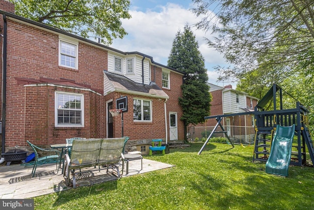 104 Lowrys Ln, Bryn Mawr, PA 19010 - back of property with a playground, brick siding, a patio, and a fire pit