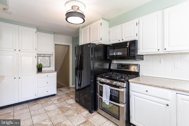 104 Lowrys Ln, Bryn Mawr, PA 19010 - kitchen with black appliances, white cabinetry, backsplash, and light stone counters