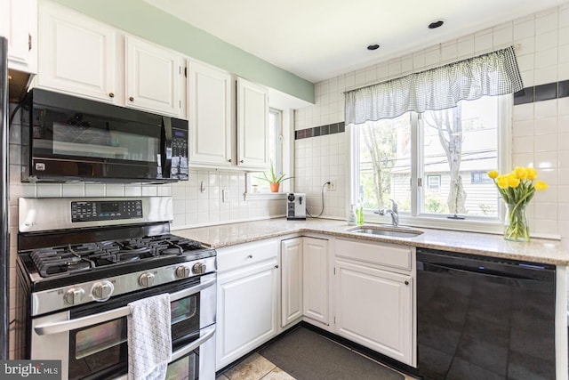104 Lowrys Ln, Bryn Mawr, PA 19010 - kitchen with black appliances, white cabinets, and tasteful backsplash