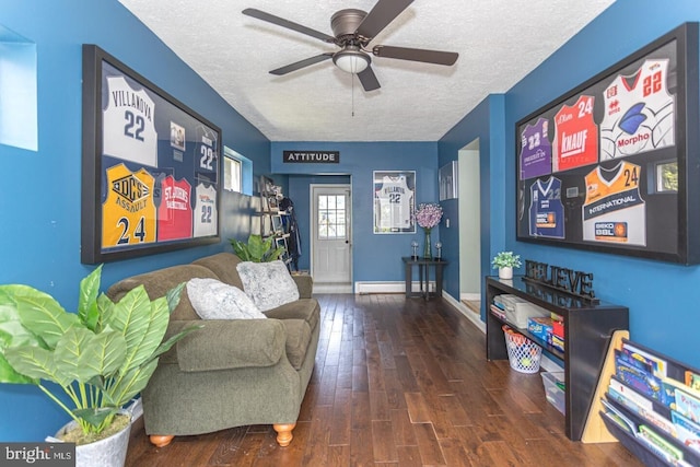 104 Lowrys Ln, Bryn Mawr, PA 19010 - living area featuring a textured ceiling, a baseboard heating unit, wood finished floors, and a ceiling fan