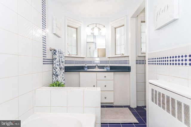 104 Lowrys Ln, Bryn Mawr, PA 19010 - full bathroom featuring tile walls, a garden tub, radiator heating unit, vanity, and tile patterned flooring
