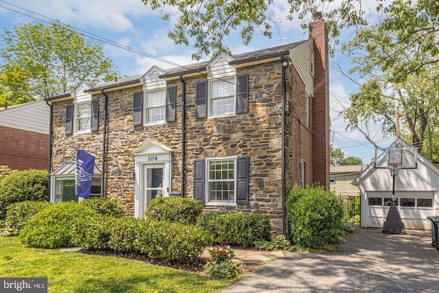104 Lowrys Ln, Bryn Mawr, PA 19010 - multi unit property with stone siding, a chimney, an outdoor structure, and a detached garage