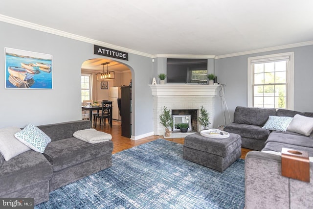 104 Lowrys Ln, Bryn Mawr, PA 19010 - living room featuring crown molding, arched walkways, and a fireplace