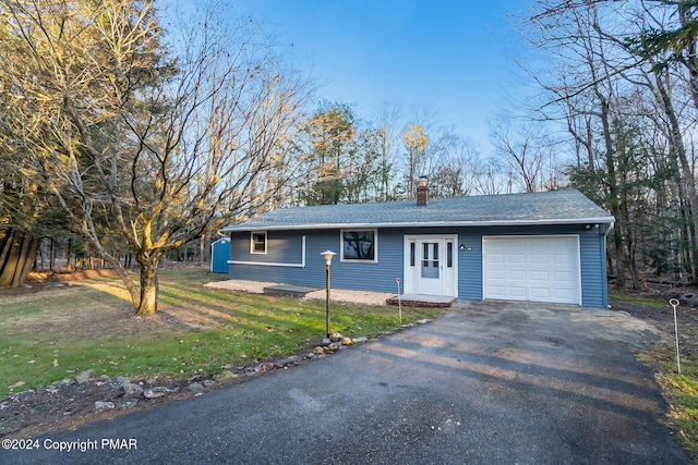 ranch-style home with a garage, driveway, a chimney, and a shingled roof