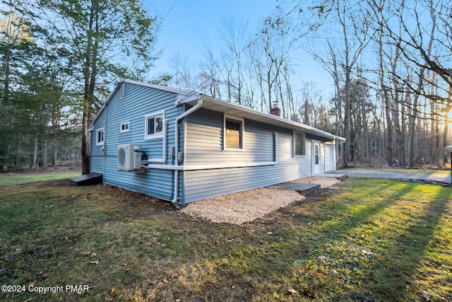 view of property exterior featuring a yard, a chimney, and ac unit