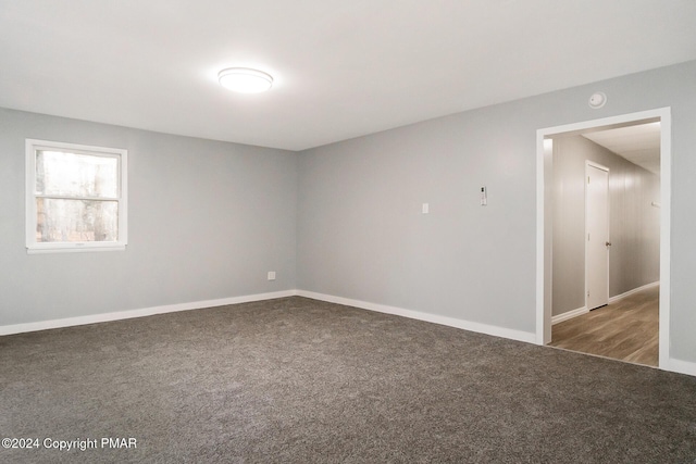 carpeted empty room with baseboards