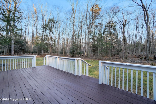 wooden deck featuring a lawn