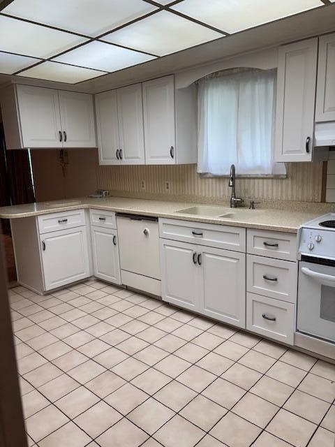 kitchen featuring a sink, light countertops, white cabinets, white appliances, and extractor fan