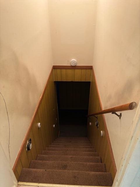 staircase featuring a towering ceiling