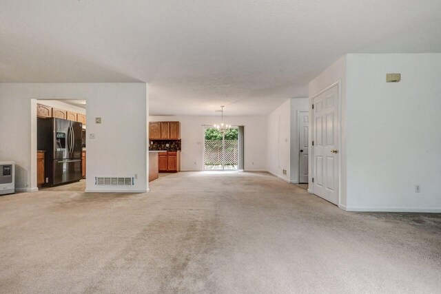 1162 Colt Ln, Pocono Summit, PA 18346 - unfurnished living room with a chandelier and light carpet