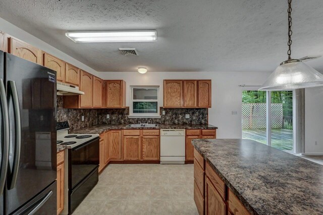 1162 Colt Ln, Pocono Summit, PA 18346 - kitchen with freestanding refrigerator, black range with electric stovetop, white dishwasher, under cabinet range hood, and a textured ceiling