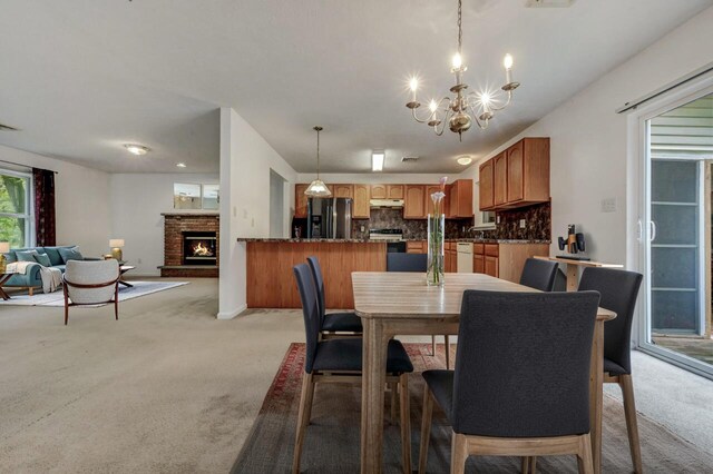 1162 Colt Ln, Pocono Summit, PA 18346 - dining area with light colored carpet, a chandelier, and a fireplace