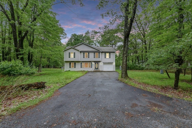 1162 Colt Ln, Pocono Summit, PA 18346 - view of front of property featuring asphalt driveway, a garage, and a lawn