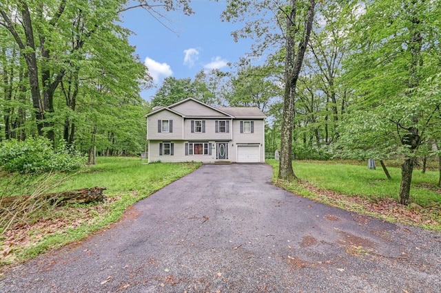 1162 Colt Ln, Pocono Summit, PA 18346 - view of front facade featuring asphalt driveway, an attached garage, and a front lawn