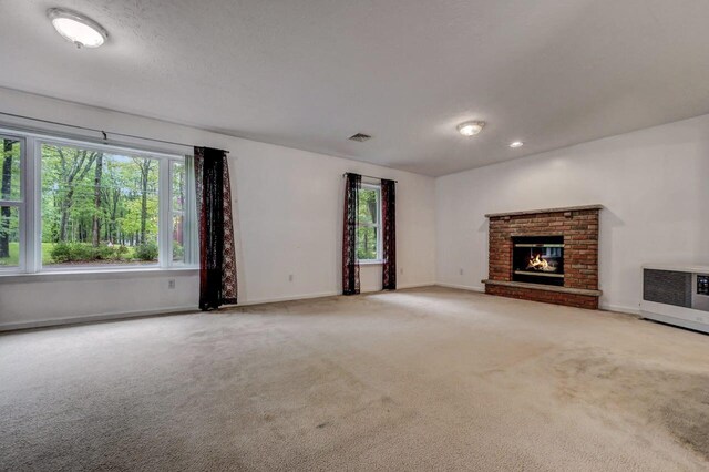 1162 Colt Ln, Pocono Summit, PA 18346 - unfurnished living room with carpet floors, a fireplace, and heating unit