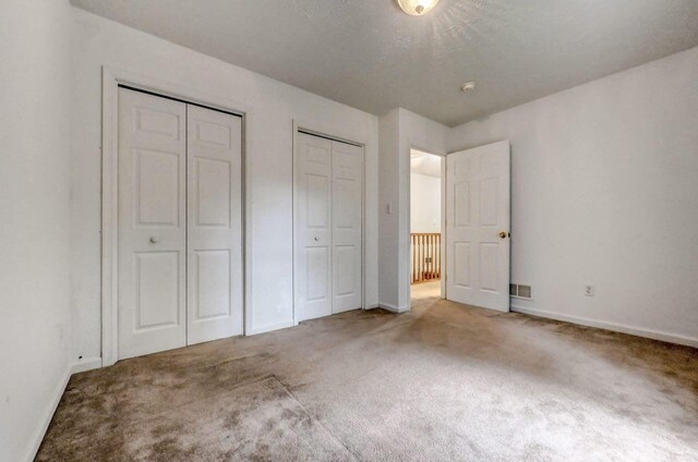 1162 Colt Ln, Pocono Summit, PA 18346 - unfurnished bedroom featuring multiple closets and carpet