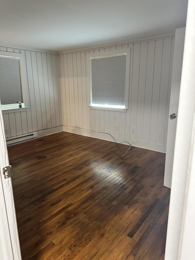 4932 Pine Ridge Dr W, Bushkill, PA 18324 - spare room with dark wood-style flooring, baseboard heating, and wood walls