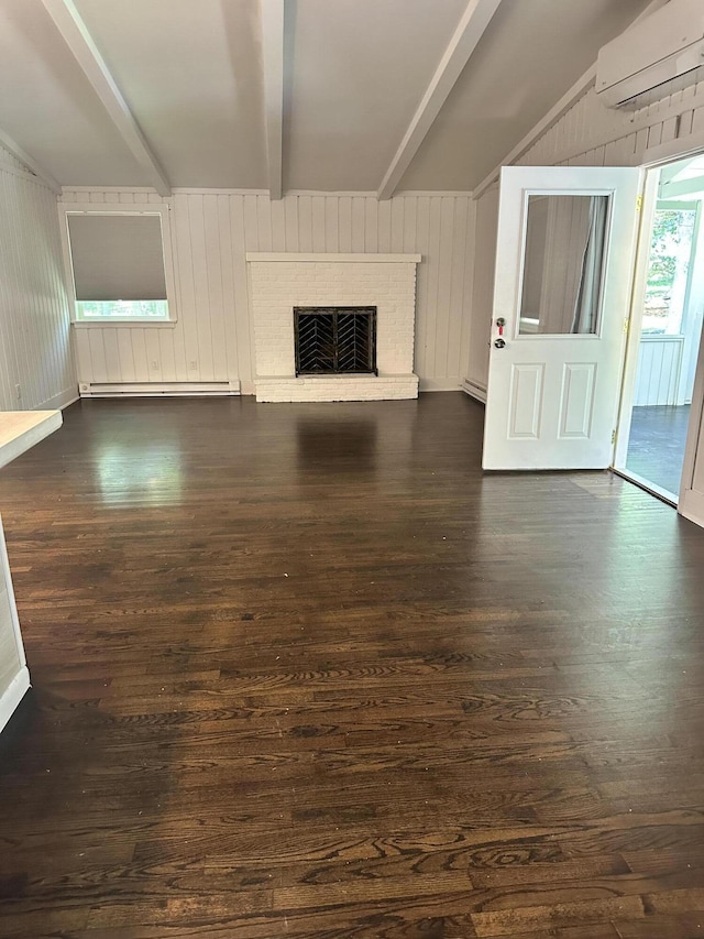 4932 Pine Ridge Dr W, Bushkill, PA 18324 - unfurnished living room featuring a wall unit AC, beamed ceiling, dark wood-style flooring, a brick fireplace, and wood walls