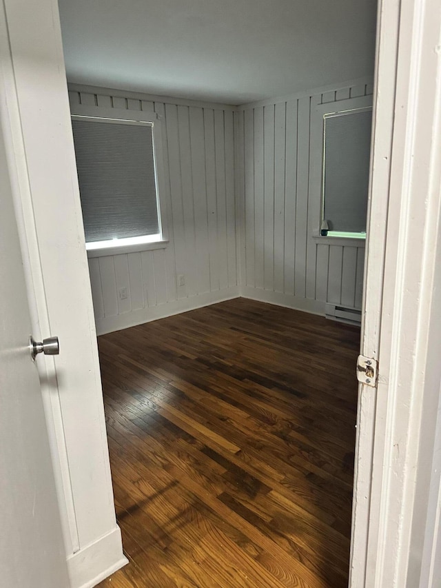 4932 Pine Ridge Dr W, Bushkill, PA 18324 - spare room with dark wood-style floors, a baseboard radiator, and wood walls