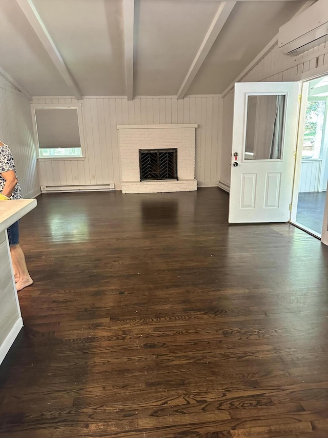 4932 Pine Ridge Dr W, Bushkill, PA 18324 - unfurnished living room featuring a wall unit AC, dark wood finished floors, a fireplace, wooden walls, and a baseboard radiator