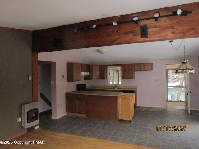 kitchen featuring vaulted ceiling with beams, heating unit, a healthy amount of sunlight, range, and under cabinet range hood