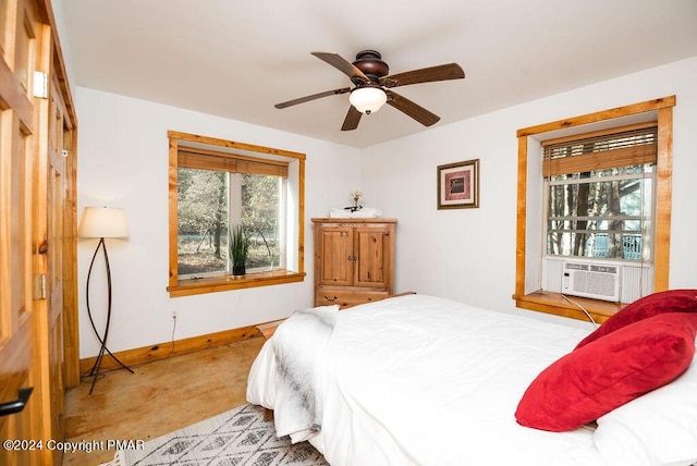 bedroom with cooling unit, a ceiling fan, and baseboards