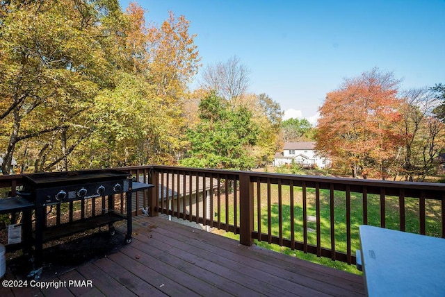 wooden terrace featuring a yard