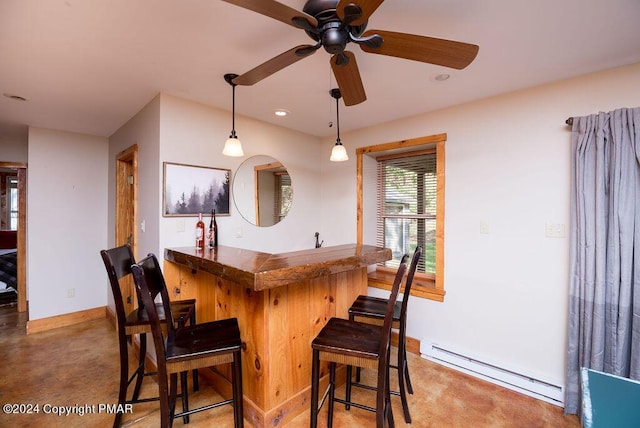 bar with baseboards, a ceiling fan, wet bar, baseboard heating, and pendant lighting