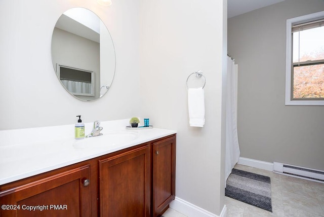 full bathroom with a baseboard radiator, vanity, and baseboards