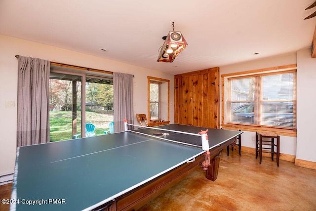 rec room featuring concrete floors and baseboards