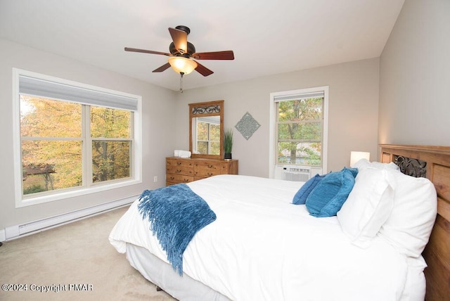 carpeted bedroom with a ceiling fan, a baseboard heating unit, and cooling unit