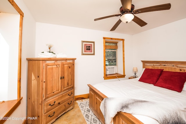 bedroom with cooling unit and ceiling fan