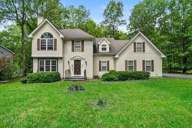 194 White Pine Trl, East Stroudsburg, PA 18301 - view of front facade with a chimney, a front lawn, and a shingled roof