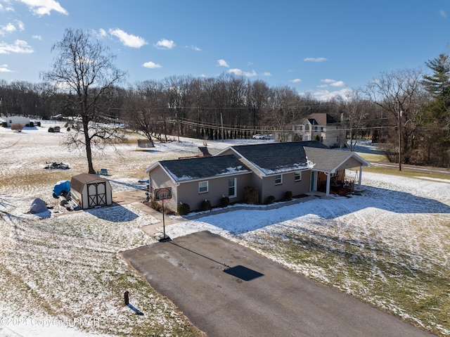 view of front of home with a storage shed and an outbuilding