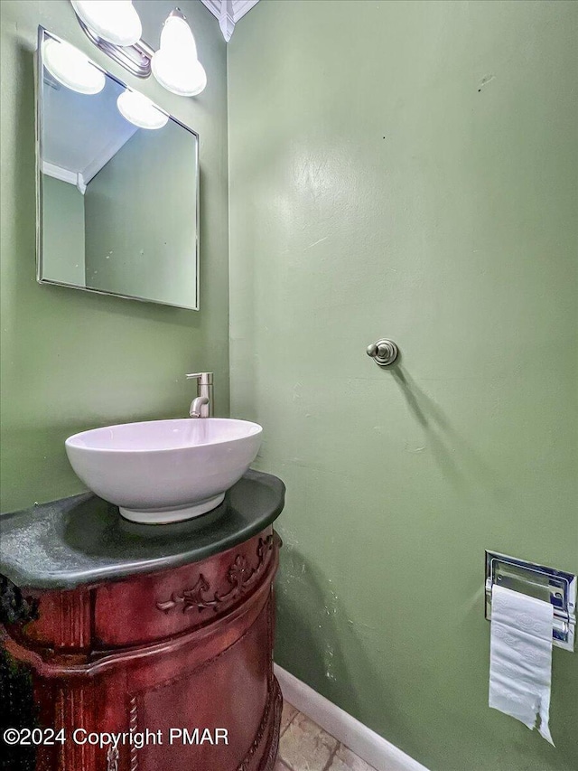 bathroom with vanity and baseboards