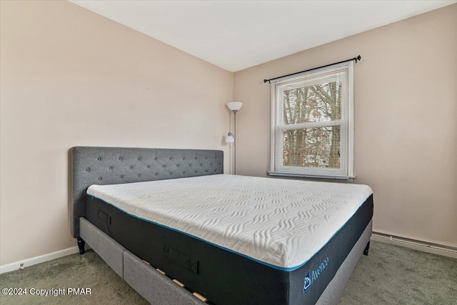 bedroom with baseboards and light colored carpet