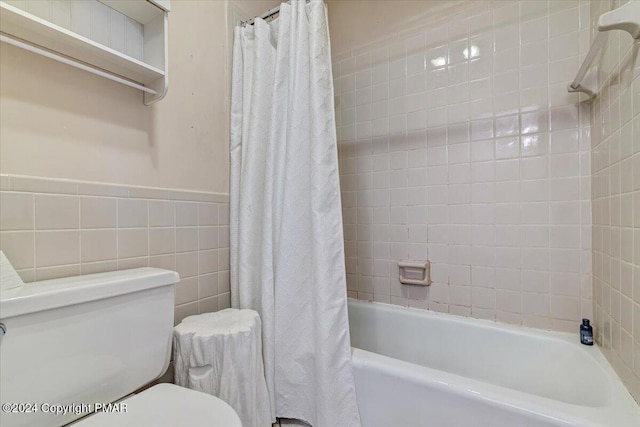 full bathroom with shower / bath combo, tile walls, and toilet