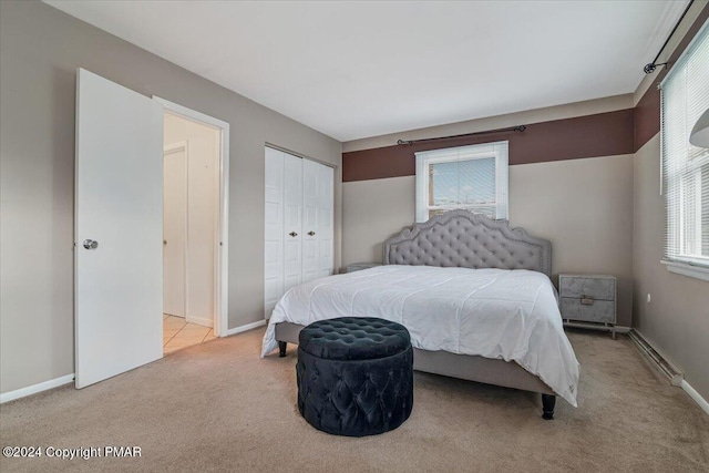 carpeted bedroom with baseboards, baseboard heating, and a closet