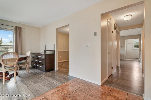 dining room featuring plenty of natural light, baseboards, and light wood-style flooring