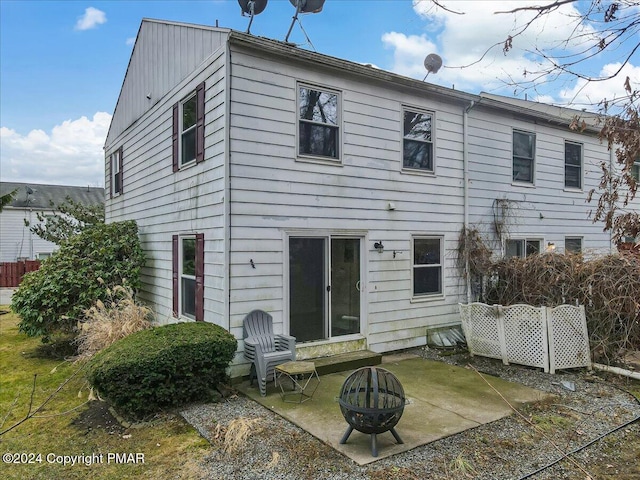 rear view of property with a patio area, fence, and a fire pit