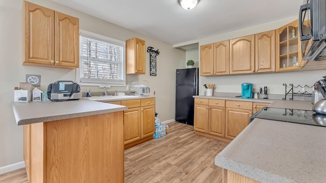 9148 Brandywine Dr, Tobyhanna, PA 18466 - kitchen with freestanding refrigerator, light wood-type flooring, glass insert cabinets, and a sink