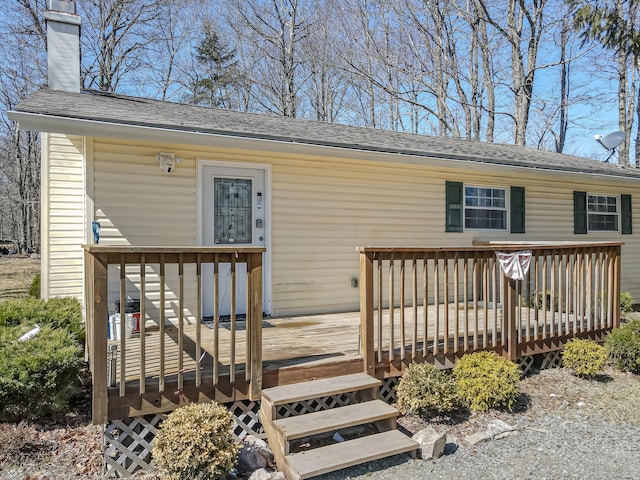 9148 Brandywine Dr, Tobyhanna, PA 18466 - view of exterior entry featuring a deck, a chimney, and roof with shingles