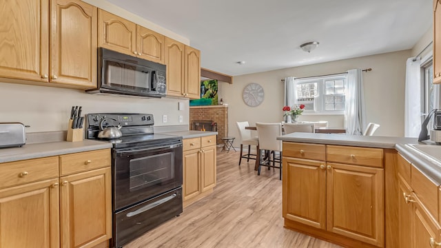 9148 Brandywine Dr, Tobyhanna, PA 18466 - kitchen featuring black appliances, plenty of natural light, and light wood-style floors