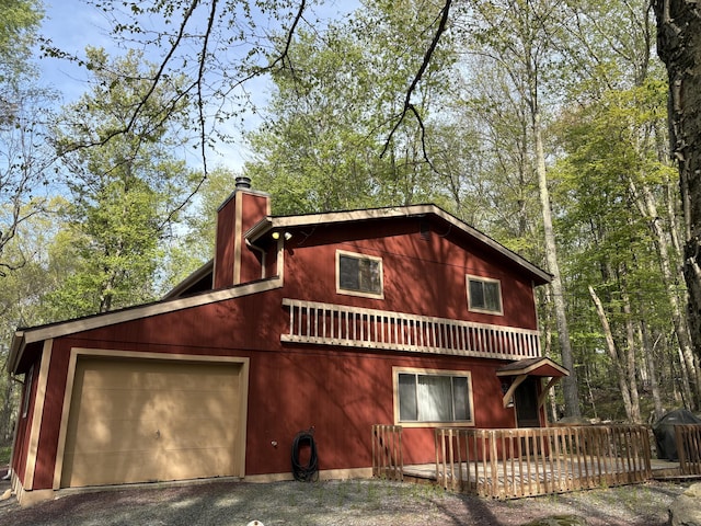 368 Ridge Rd, Pocono Lake, PA 18347 - chalet / cabin featuring a chimney, a wooden deck, and driveway