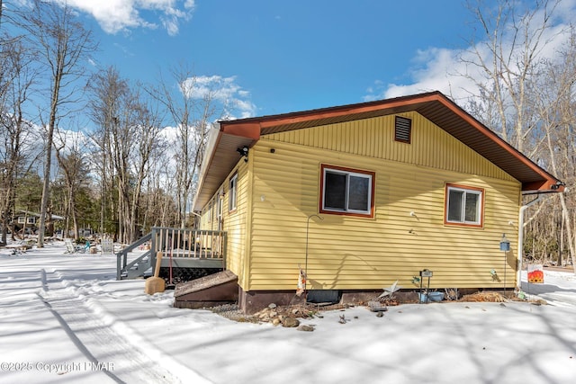 snow covered property featuring a deck