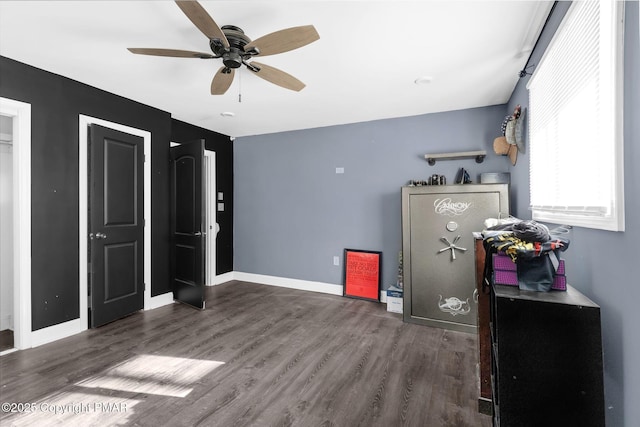 bedroom with dark hardwood / wood-style flooring and ceiling fan