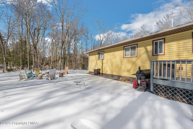 view of snowy exterior with a patio area