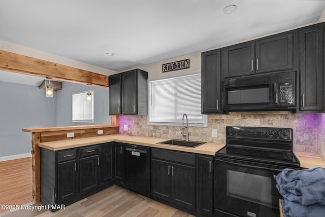 kitchen with sink, tasteful backsplash, kitchen peninsula, light hardwood / wood-style floors, and black appliances